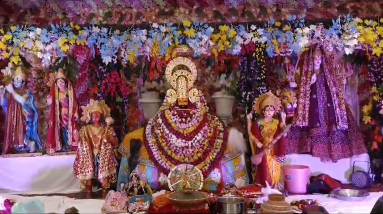 Colorful devotional setup with floral backdrop
